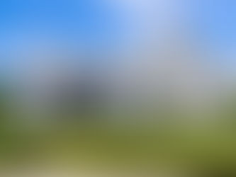 White brick custom home in Cincinnati featuring classic gabled rooflines, stone accents, and refined exterior architecture designed by Frazier Homes.