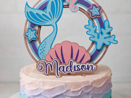Handmade 3D cake topper created from layered card, showing depth, structure and raised design details.