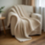 a cosy book corner with an armchair and a chunky woollen throw draped over it