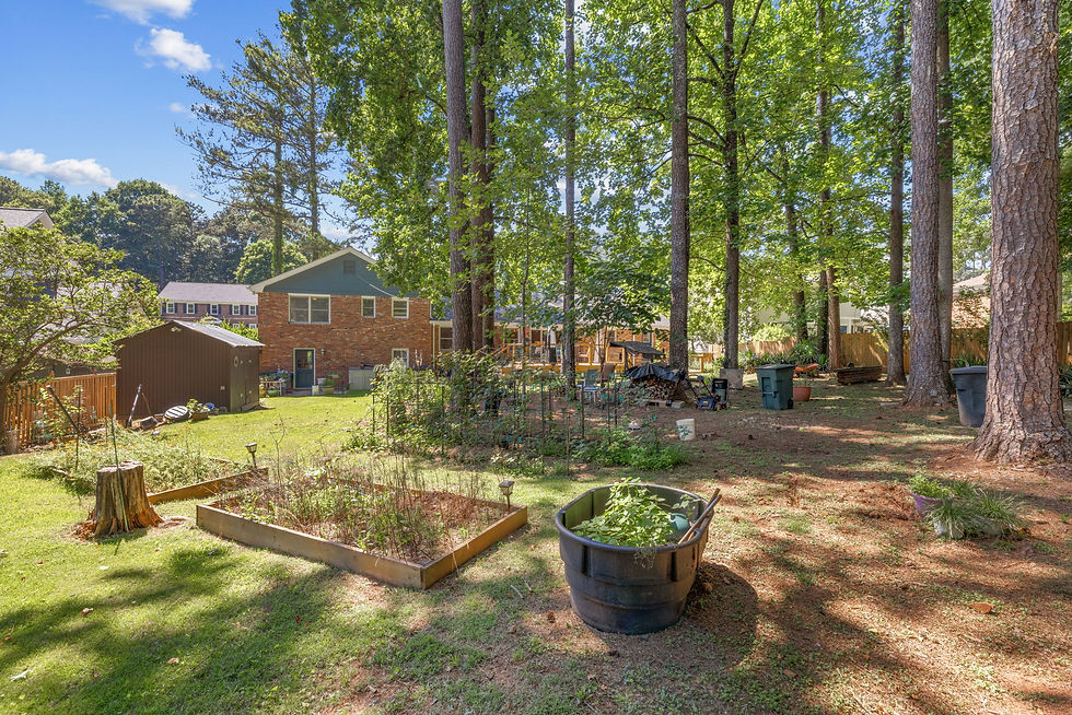 | Backyard | Fenced backyard with garden beds and firepit area in Habersham Atlanta, GA |
