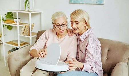 imgi_71_senior-woman-holding-smart-vacuum-cleaner.jpg