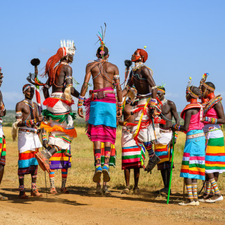 Maasai people in traditional dress participating in a cultural dance during an African safari experience