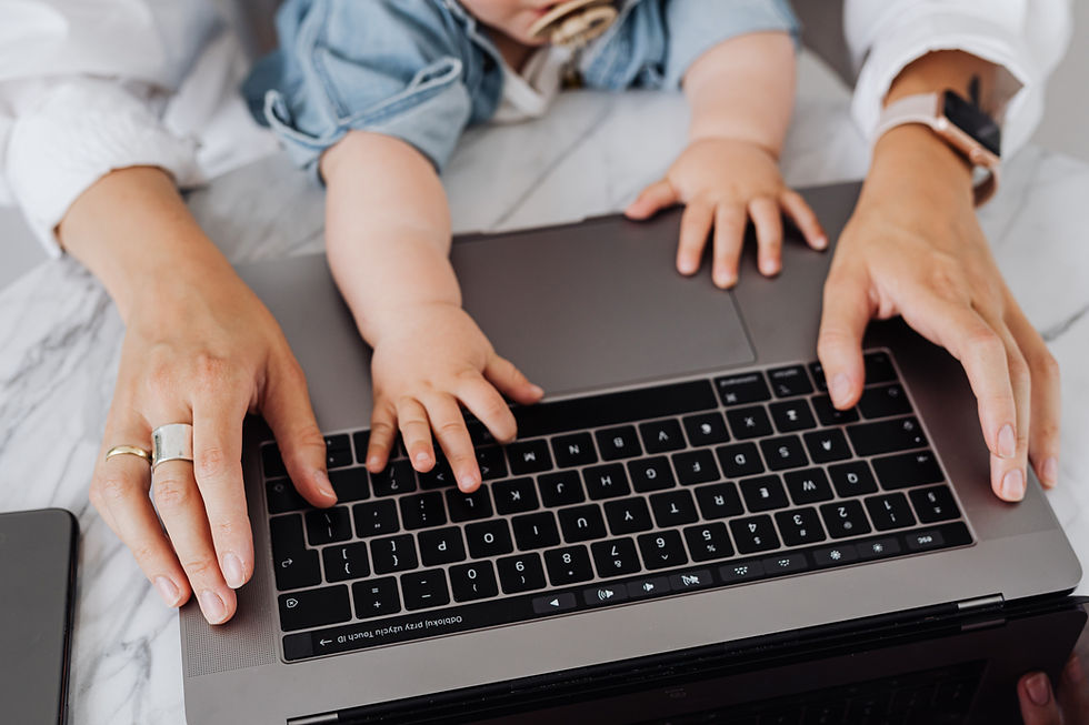Mom and baby in her lap type on a laptop keyboard