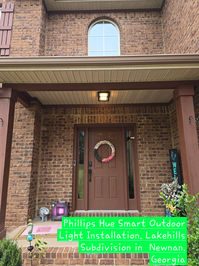 Certified Electrician installing outdoor L.E.D light.