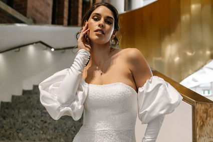 Beaded strapless wedding dress with side split and removable bridal accessory sleeves in satin.