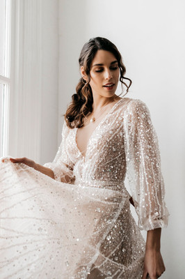 Balloon sleeve wedding dress with sparkling fabric.