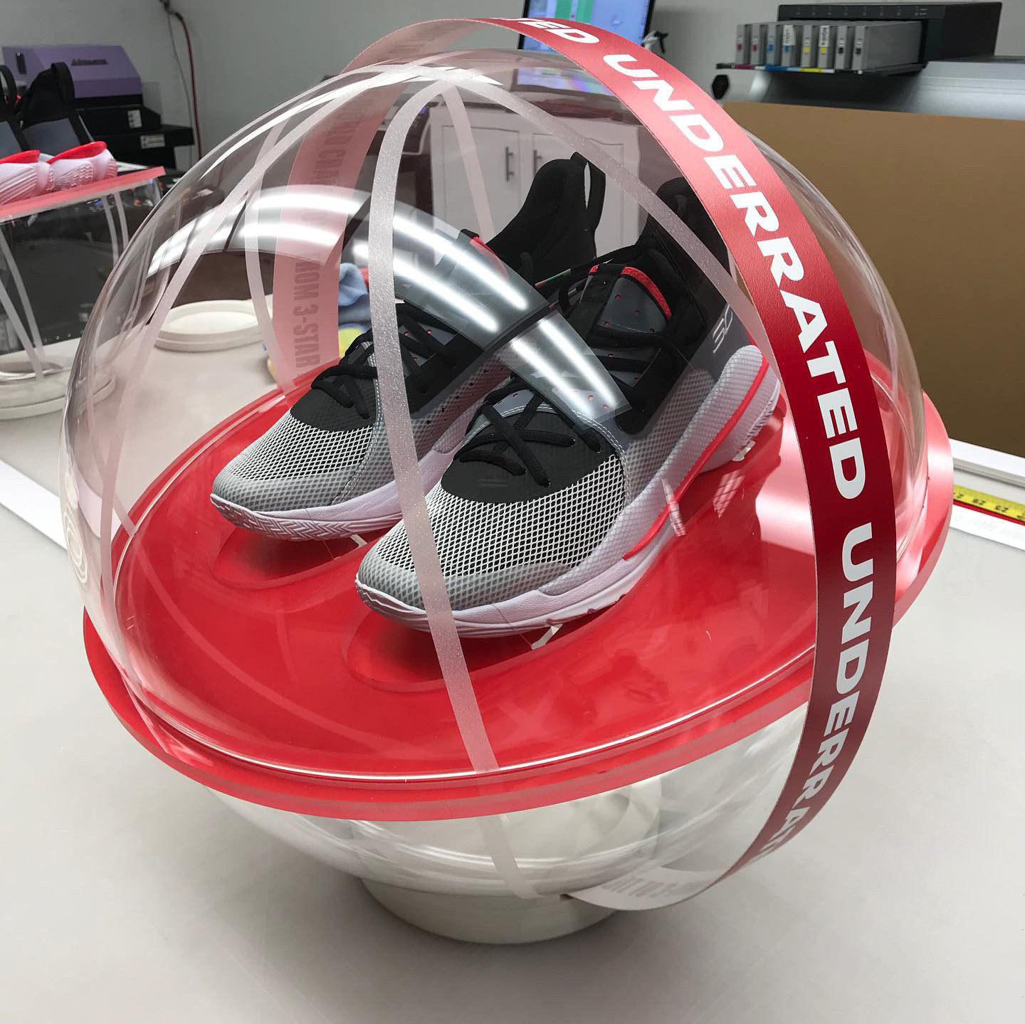 An acrylic globe used to protect a signature pair of tennis shoes