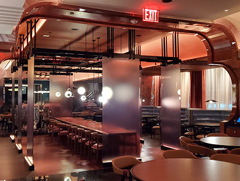 Seating area for a restaurant in New York. Brass details and custom millwork.