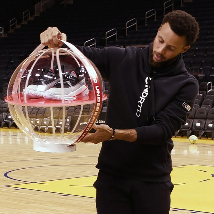 Steph Curry unveiling the globe with shoes on a basketball court