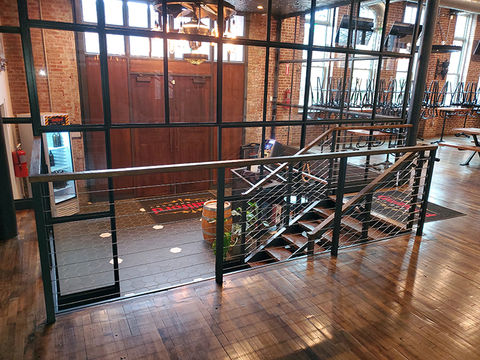 Industrial railing and stair well with patina finish and modern look