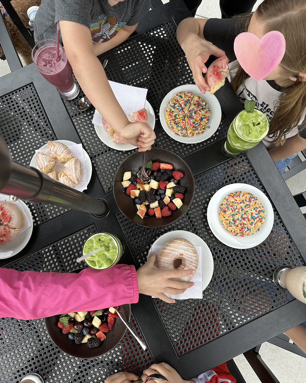 kids sharing a meal outside at a table
