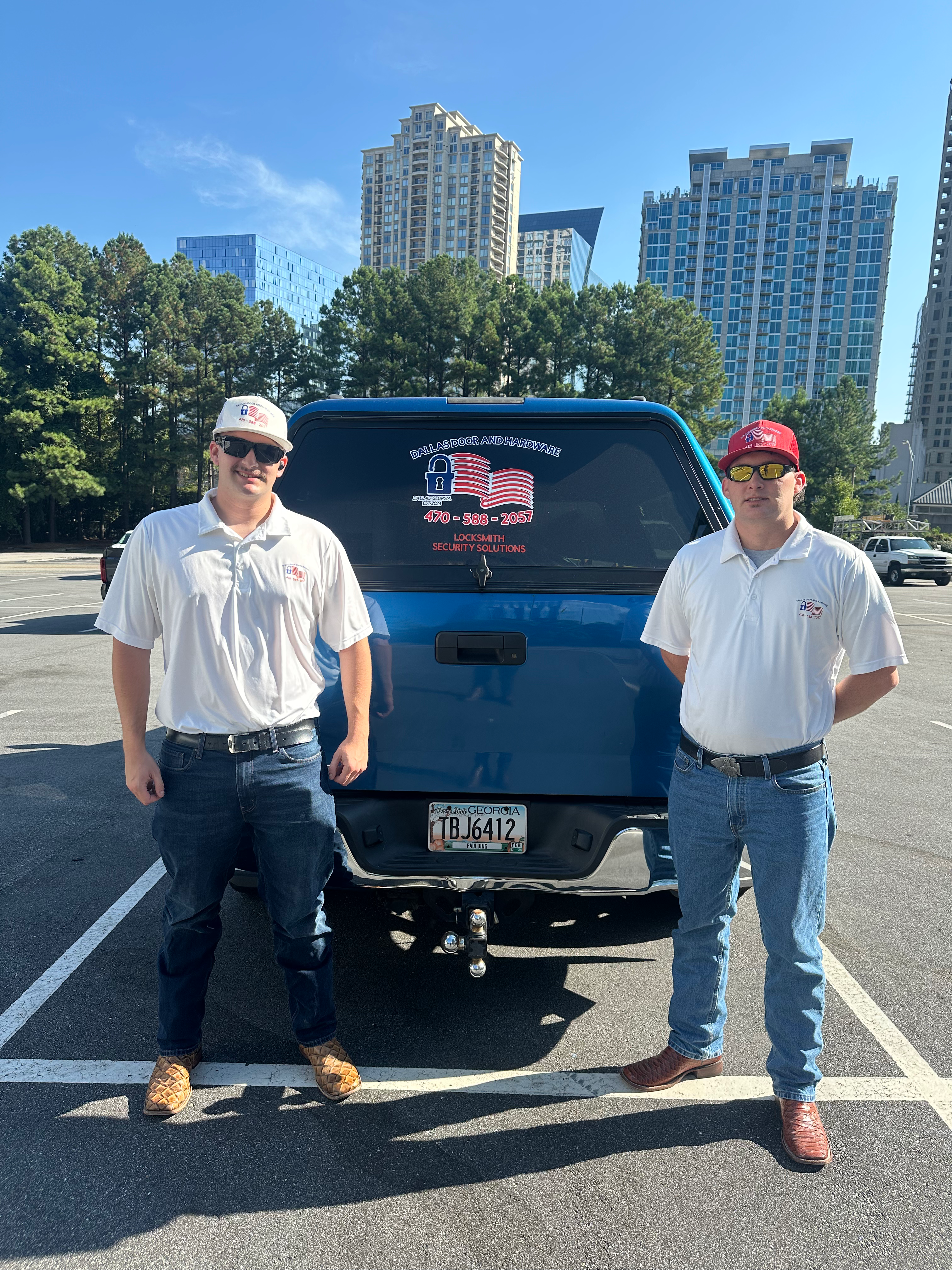 Dallas Door and Hardware team beside the company blue service truck