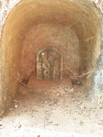 Ancient Shrine Cave with Stone Relief of two entwining Snakes, Gokarna, Karnataka, India, February 2014.