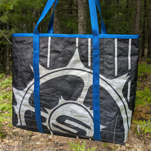 large beach bag with blue straps and silver slingshot kiteboarding "stickyball" logo