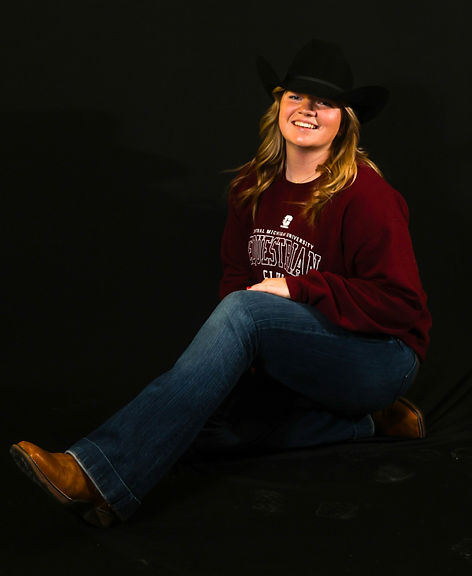 Central Michigan University junior Jenna Hubert poses for a sportrait themed picture in Moore Hall, Tuesday, December 2, 2025. Hubert is CMU equestrian stock captain qualifying for the 2024-25 regionals in Midland. Camera settings: 1/250, 55mm lens, f/5.6, ISO 800. Flashes A,B,C 1/64.
