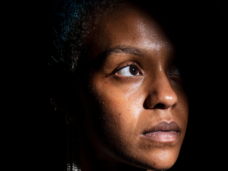 A woman feeling isolated, contemplating group therapy at Alliance Wellness Solutions