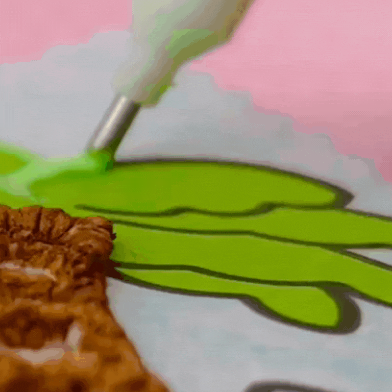 Colored Coloring Page of palm trees at the beach being colored with green puff paint, set against a pink background. The scene is colorful and creative.