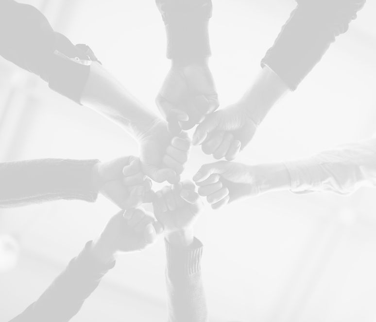 A group of fists joining together in a circle, symbolizing unity, strength, and solidarity.