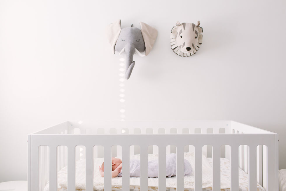 newborn baby boy sleeping in crib at home