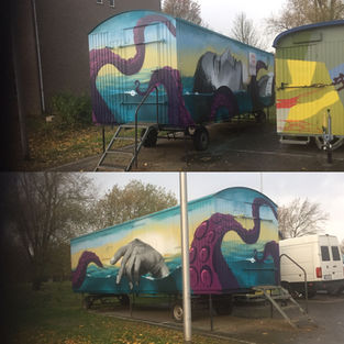 painted trailer with tentackles and a hand and face emerging out of the water