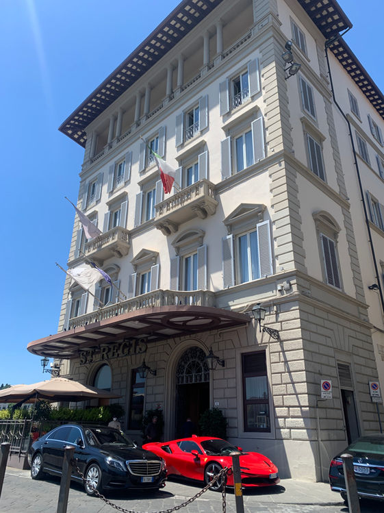 Building with visible text and cars. Hotel Baglioni Firenze in Florence