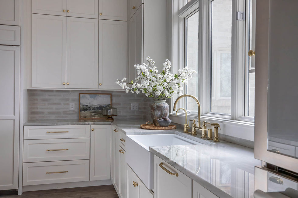 White kitchen with farmhouse sink and gold faucet