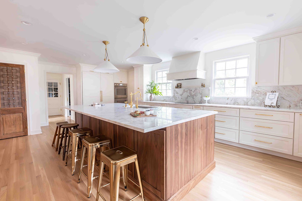 Modern kitchen with wood island, white marble, and bar stools