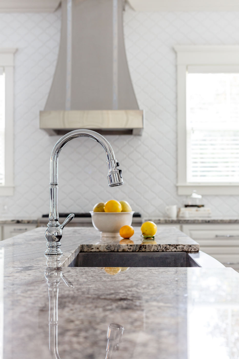 Kitchen island with sink, chrome faucet, and lemons