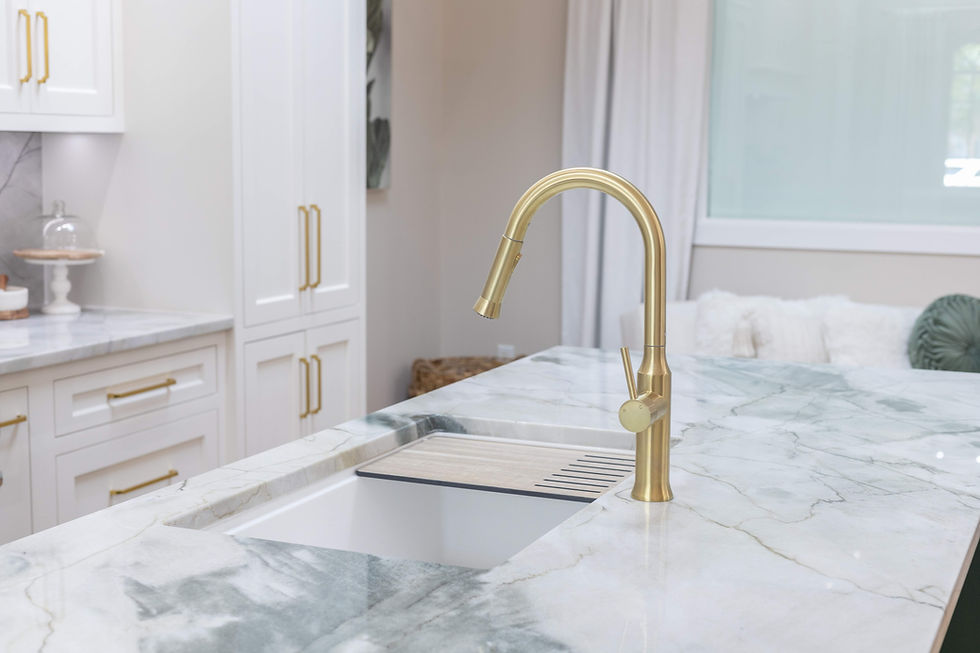 Gold faucet, white sink, marble kitchen counter