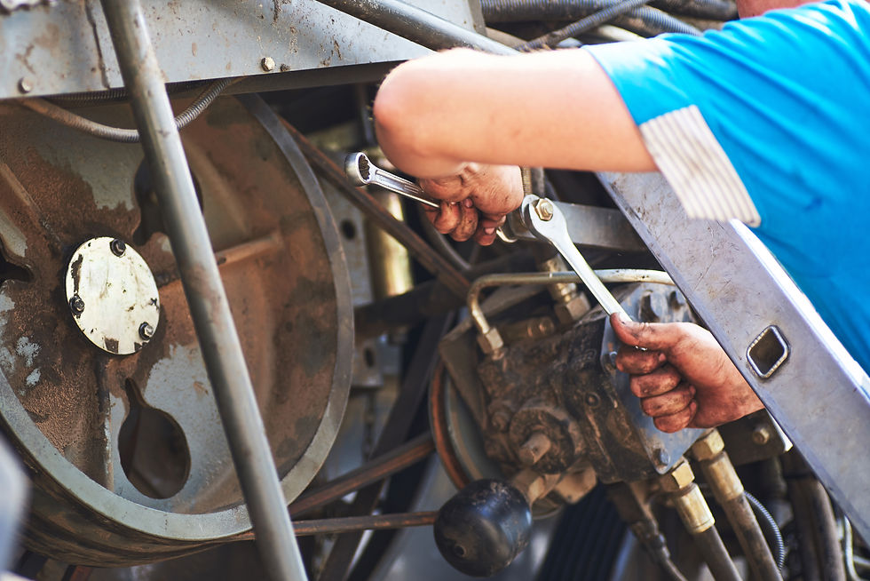 Mechanic performing machinery maintenance