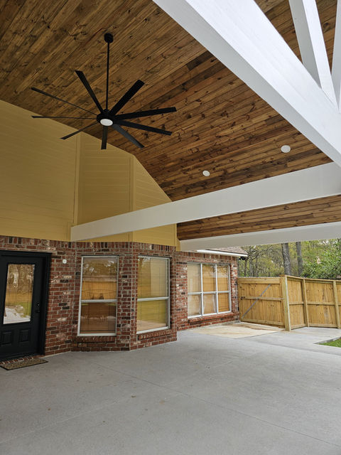 Modern patio with wood ceiling and large ceiling fan