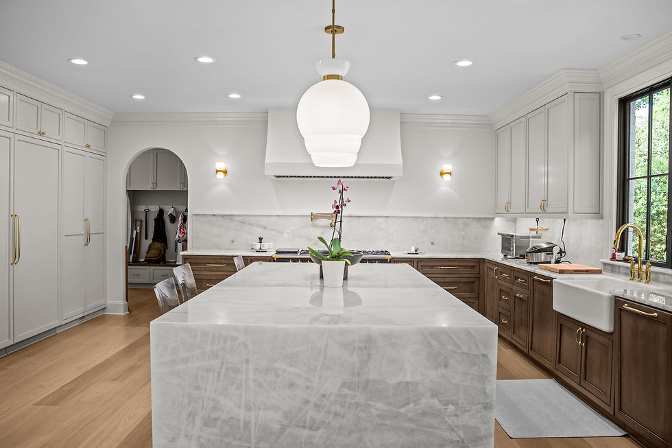 Modern kitchen with marble island and wood cabinetry