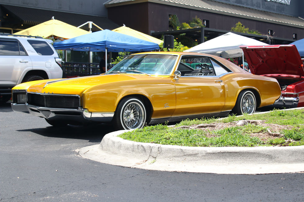A Gold 2nd Generation Buick Riviera at a Car Show