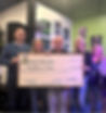 Board of Directors members receive a check of money raised at Angelina's Song Annual Bands & Beer Bash, 2024