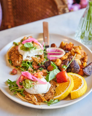 Delicious breakfast: Poached eggs, chorizo, potatoes, and fruit