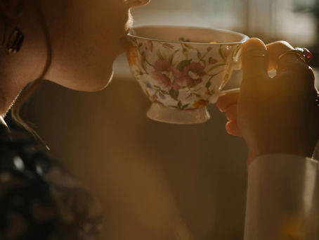 Hands holding a steaming mug of herbal tea, evoking warmth and calm