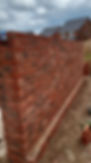 A corner view of a newly constructed brick wall
