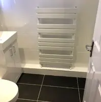 a picture showing bathroom with a hanging radiator 