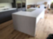 Modern kitchen interior with a large island and dark cabinets