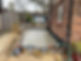 Freshly poured concrete slab beside a brick house