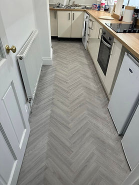 Chevron-patterned gray kitchen floor