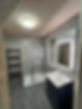 A Modern bathroom with a glass shower enclosure and grey stone tiles