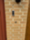 A doorbell camera on a textured brick wall