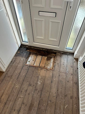 Damaged wooden floor near door