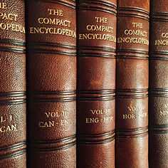 A close-up of leather bound volumes of The Compact Encyclopedia