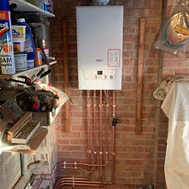 A boiler with copper pipes is installed