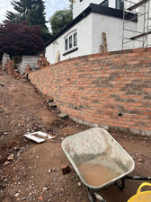 Construction site featuring a partially built brick wall