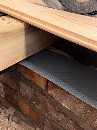 Wooden beam over brick wall