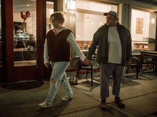 couple walking hand in hand during couples photos in Madison Indiana