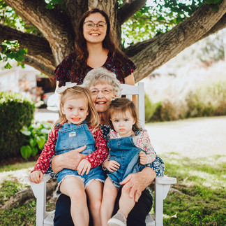Grandparents sharing a special moment with great grandchildren during extended family photos